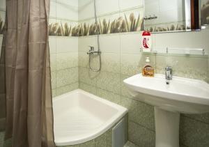 布哈拉Dervish Hostel的浴室配有盥洗盆、浴缸和盥洗盆