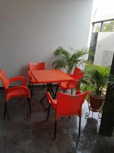 瓦加杜古RÉSIDENCE HÔTELIÈRE KAWEROU的庭院里一套红色的桌椅