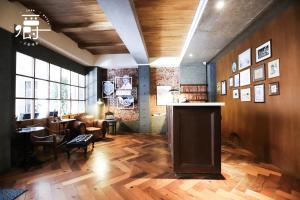 台南古根嚼旅的客厅铺有木地板,配有桌子。