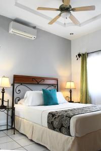马塔加尔帕Hotel San Jose, Matagalpa.的一间卧室配有一张带吊扇的床