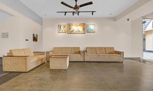 科钦Treebo Trend Grand Vistara Airport Suites的客厅配有两张沙发和吊扇