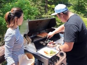 藏王温泉山阁罗山林小屋的烤架上做饭的男人和女人