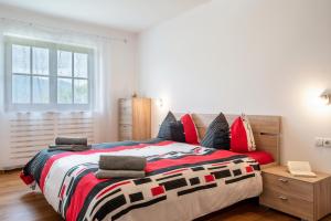 修希Apartement Santner的一间卧室配有一张大床和色彩缤纷的毯子
