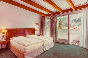 卡尔达罗Amadeus Ora & Amore的一间卧室设有一张床和一个大窗户