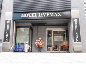 东京HOTEL LiVEMAX Tokyo Ayase-Ekimae的满花束的酒店跑道前的商店