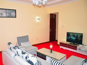姆特瓦帕蒙娜丽莎酒店的客厅配有白色家具和平面电视