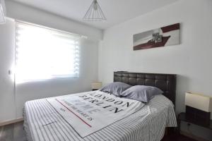 勒卡内Le Cannois的一间卧室,配有一张带标志的床