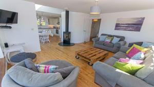 布朗顿Rooftops Braunton, Stylish Beach House - Fantastic Views - Hot Tub hire - Sleeps 8的客厅配有两张沙发和一张木制咖啡桌