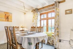 纽基Victoria Cottage的一间带桌椅和窗户的用餐室