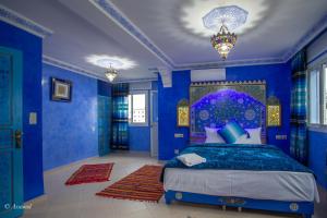 舍夫沙万阿苏尔普尔塔住宿加早餐旅馆的一间拥有蓝色墙壁的卧室,其中配有一张床