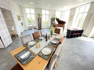 波朗特吕The 5 Continents I by Stay Swiss的一间带桌子和钢琴的用餐室