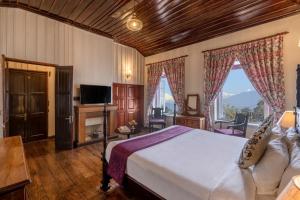 噶伦堡Sterling Park Kalimpong的一间卧室设有一张床、一台电视和窗户。