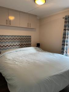 洪德洛Luxe Chalet Hoenderloo Airco, Netflix - Recreation Only的卧室配有一张白色大床