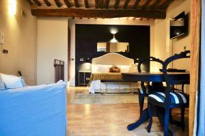 蒙塔尔奇诺suite la fortezza的一间卧室配有一张床和一张桌子及椅子