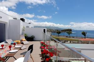 蓬塔德尔加达Consuls Ocean View的一个带桌椅的海景阳台