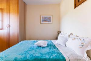 PanasósStella的卧室配有带白色枕头的大型蓝色床