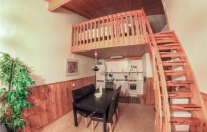 布拉纳斯Amazing Home In Sysslebck With House A Mountain View的厨房以及带木楼梯和桌椅的用餐室。