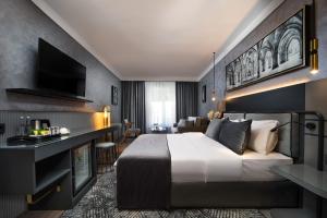 安卡拉The Wings Hotels Neva Palas的一间带大床的卧室和一间客厅