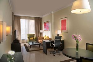 迪拜Two Seasons Hotel & Apartments的客厅配有沙发和桌子
