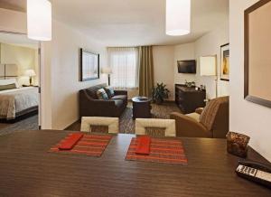欧弗兰帕克MainStay Suites- Kansas City Overland Park的酒店客房设有床和客厅。