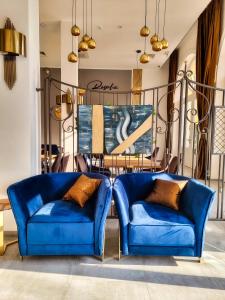 茨里克韦尼察Heritage Hotel Stypia的一张桌子的房间里摆放着两把蓝色的椅子