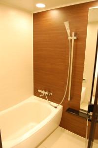 白马村大白马公寓的设有带浴缸和淋浴的浴室。