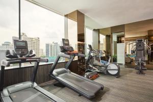 新加坡Quincy Hotel Singapore by Far East Hospitality的健身房设有2台跑步机和2辆健身自行车