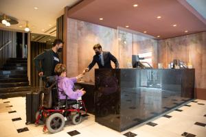 马德里丽晶酒店的坐在柜台前的轮椅上的女人