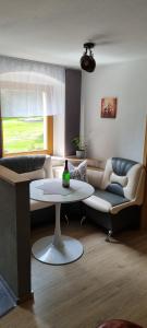 巴特戈特洛伊巴Ferienwohnung Raabsteine的客厅配有沙发和桌子