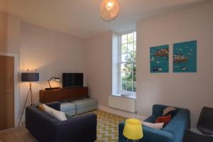 奇切斯特Beautiful flat in luxury Graylingwell development的客厅配有2张蓝色的沙发和窗户
