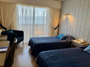 埃维昂莱班帕诺拉马酒店-餐厅的酒店客房设有两张床和窗户。