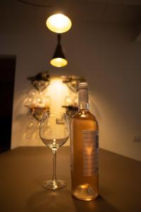 克罗托内House Room Civico 56的葡萄酒杯旁的一瓶酒