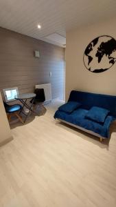 FronclesChez Madgi et Jean-Mi的客厅配有蓝色的沙发和桌子