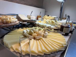 莫佐Bes Hotel Bergamo Ovest的奶酪,葡萄和其他奶酪的展示