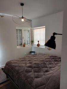 萨尔拉拉卡内达Studio2 Fontaine de L'amour的一间卧室配有一张大床和风扇