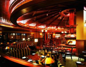 康瑟尔布拉夫斯康瑟尔布拉夫斯美洲星赌场酒店的一间带桌椅和壁炉的餐厅