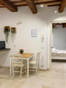雷卡纳蒂La Casa di LEO - Apartments的一间带桌椅和一张床的用餐室