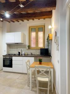 雷卡纳蒂La Casa di LEO - Apartments的厨房配有桌椅和炉灶。