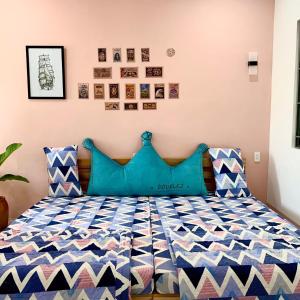 归仁1984House的一间卧室配有一张带蓝色枕头的床