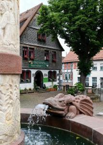 施泰瑙安德斯查瑟Burgmannenhaus的一座有雕像的建筑前的喷泉