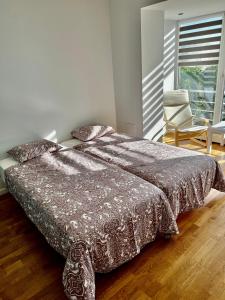 乌克梅尔盖Vilniaus 96 apartments的卧室配有床、椅子和窗户。