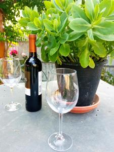 塞亚Azevinho Guest House的桌子上放有一瓶葡萄酒和两杯酒