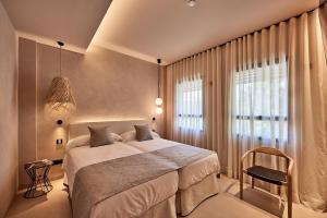 马略卡岛帕尔马JOE'S GOMILA BOUTIQUE HOTEL的一间卧室设有一张大床和一个窗户。