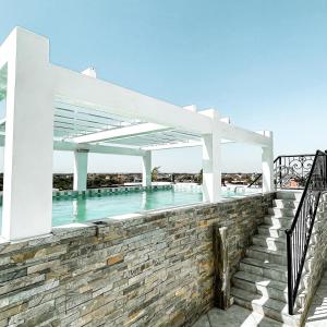 萨利波图尔KAPINGA'S HOUSE的一个带白色凉亭和楼梯的游泳池