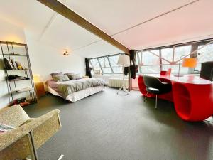 瓦讷VILLA LE LOFT - CALME & DECO - Patio intime - Salle de Cinéma - Centre Ville的一间卧室配有一张床和一张书桌