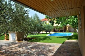 本科瓦茨Studio Apartments Luka Biograd - Benkovac的享有带游泳池的庭院景致