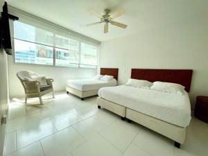 卡塔赫纳Hermoso apartamento familiar /acceso directo a la playa. Morros 3的一间卧室设有两张床、一把椅子和一个窗户。