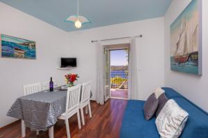 奥拉萨奇Apartments Bralovic的客厅配有桌子和蓝色沙发