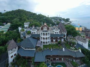 波尔多·格尼拉Tropicana Castle Dive Resort powered by Cocotel的山丘上豪宅的空中景观