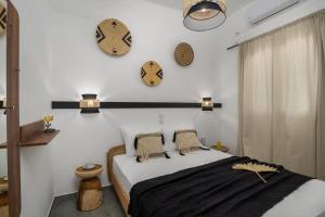 阿达玛斯Kallia's Suites Milos的卧室配有床和墙上的时钟